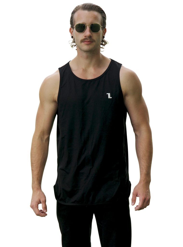 A person with long hair, a mustache, and sunglasses is wearing the Genesis Tank V2 - Black, featuring a small TL logo on the left chest, standing against a plain white background.